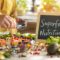 People preparing superfoods in a kitchen with 'Superfood Nutrition' handwritten on a chalkboard